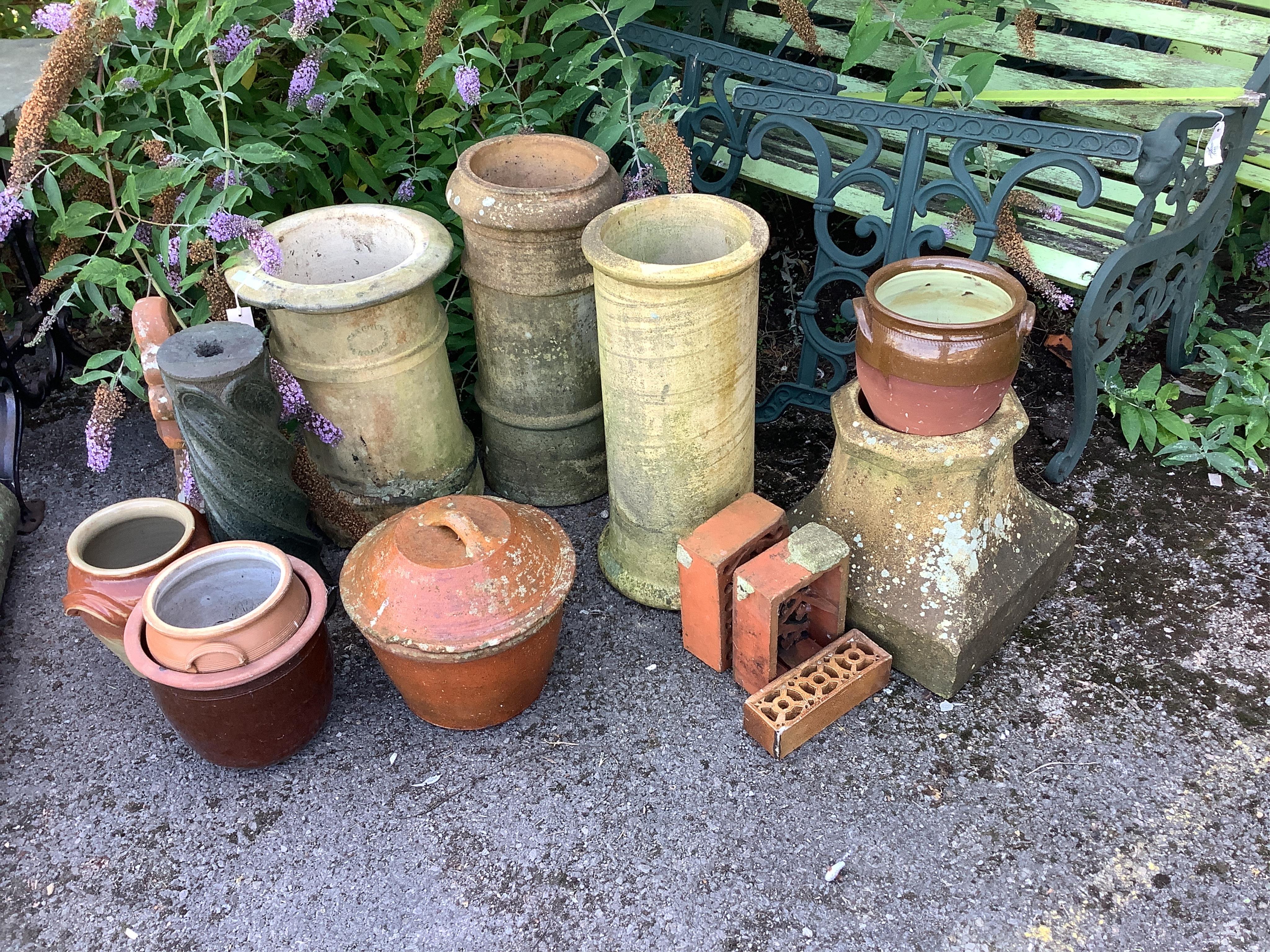 Fourteen assorted earthenware chimney pots, ridge tiles, lidded containers, etc., largest height 60cm. Condition - fair